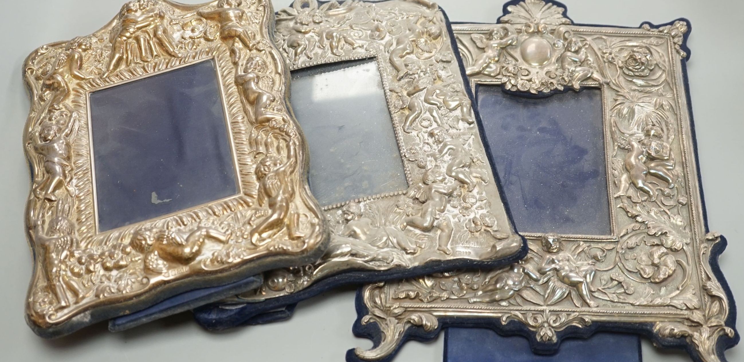 Three assorted ornate modern silver mounted photograph frames, largest overall 33.5cm.